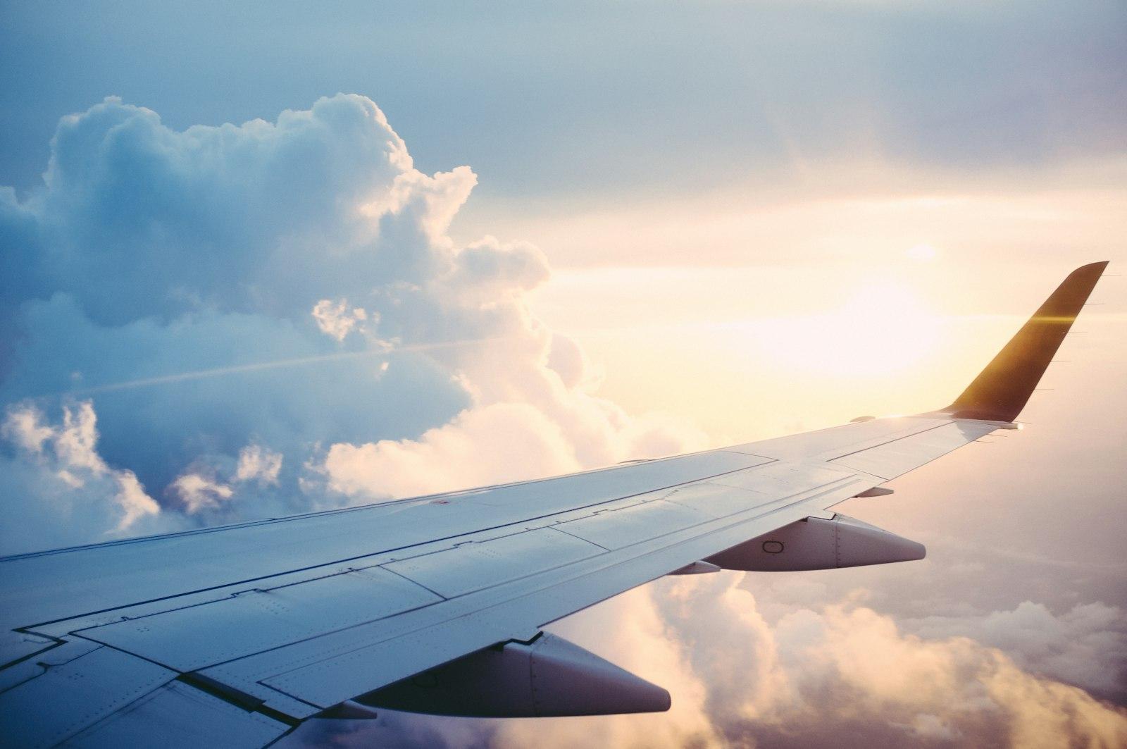 A traveler looking out of an airplane window