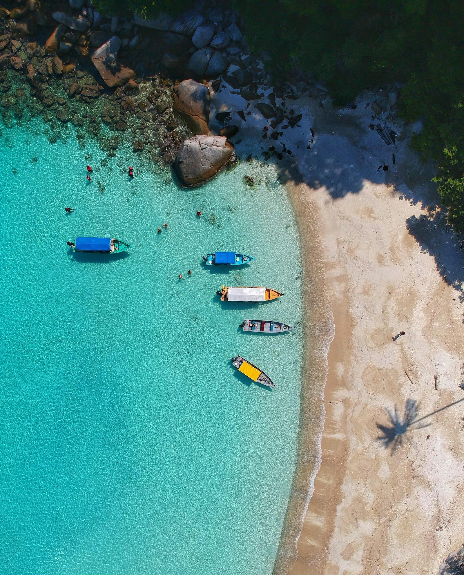 A turquoise lagoon with white sand seen from above